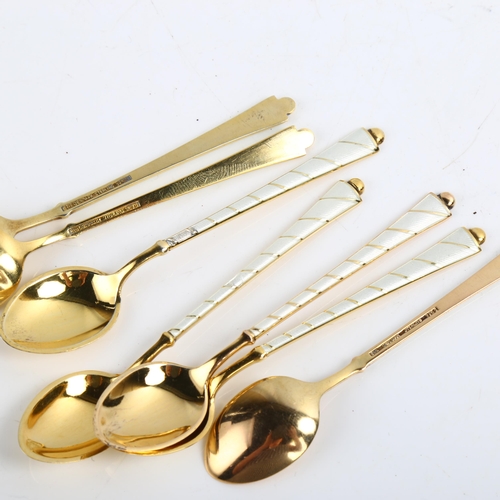 1466 - EGON LAURIDSEN - a set of 7 Danish vermeil sterling silver and white enamel coffee spoons, length 9.... 