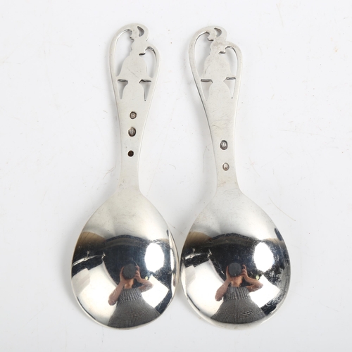 1470 - A pair of Art Deco Danish stylised silver preserve spoons, with pierced floral handles, length 11cm