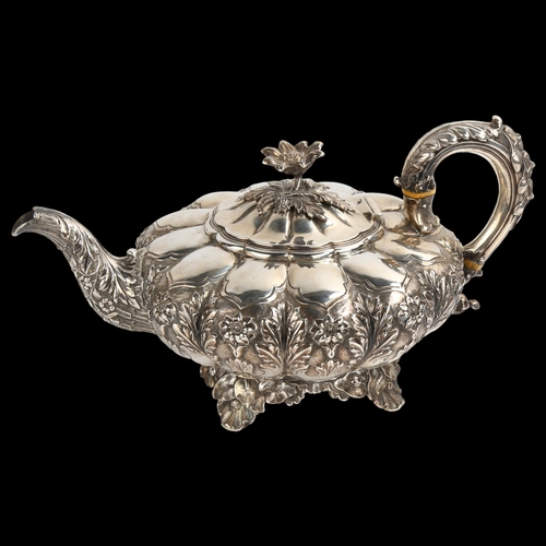 1477 - A William IV silver melon teapot, with relief embossed and chased floral decoration, flowerhead knop... 