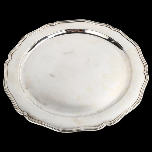 1478 - A large Portuguese silver serving platter, plain circular form with scalloped rim, eagle hallmark 91... 