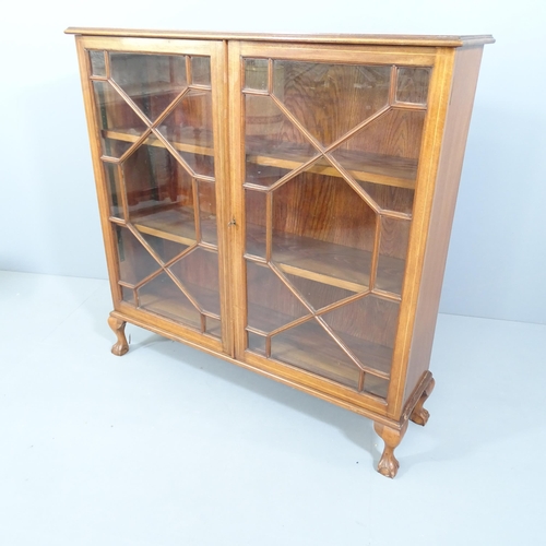 2176 - A mahogany and satinwood strung two door bookcase with two adjustable shelves and raised on cabriole... 