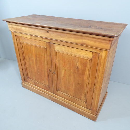 2205 - A French cherrywood sideboard, with single frieze drawer above two cupboard doors revealing a shelve... 