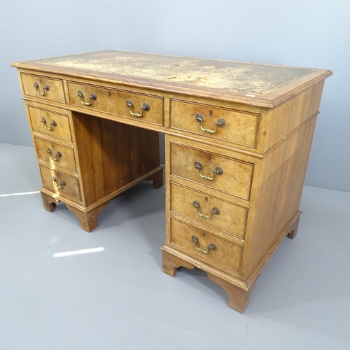 2111 - A mahogany and walnut twin pedestal writing desk, with tooled and embossed leather skiver (A/F) and ... 