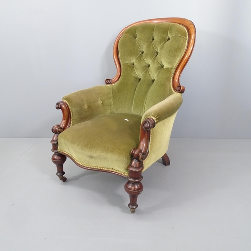 2119 - A Victorian mahogany and upholstered spoon back armchair.