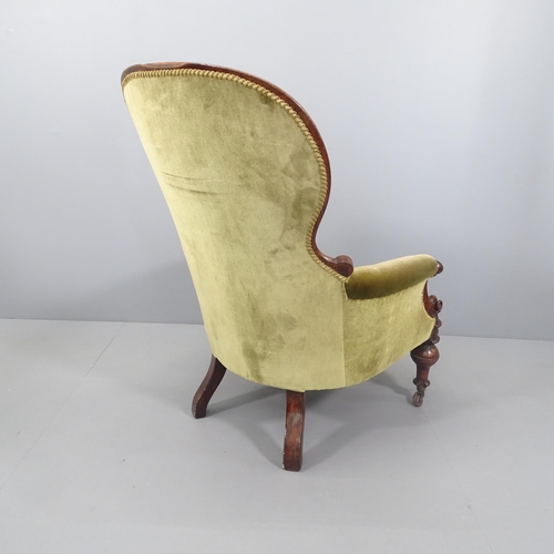 2119 - A Victorian mahogany and upholstered spoon back armchair.