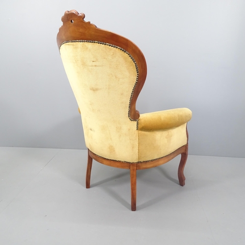 2120 - A French walnut and upholstered spoon back armchair.