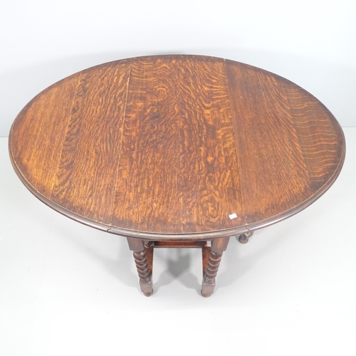 2121 - An antique oak oval gateleg table with barley twist legs. 90x74x43cm (extending to 122cm)