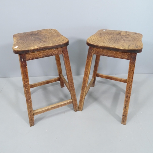 2128 - Two similar elm-seated school lab stools. Height 60cm.