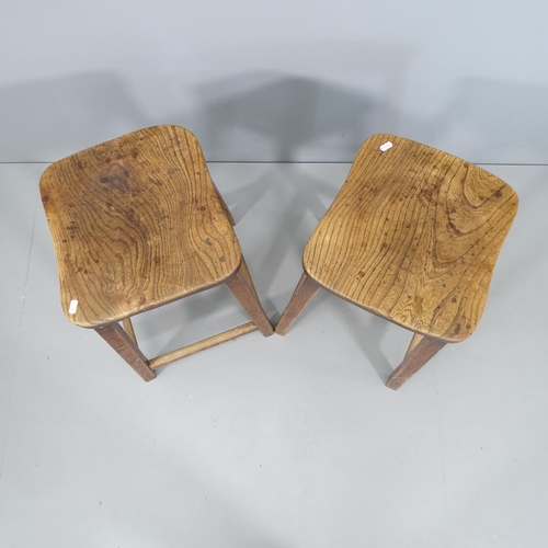 2128 - Two similar elm-seated school lab stools. Height 60cm.