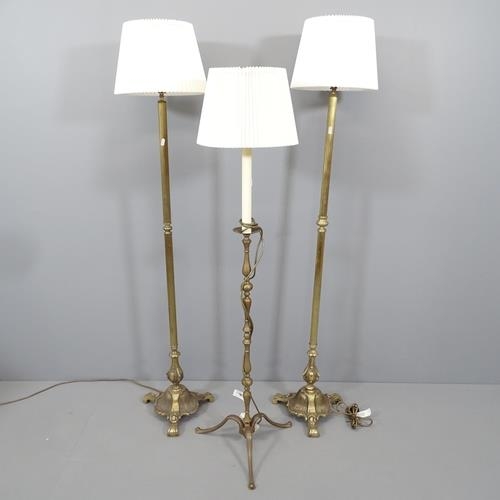 2130 - A pair of 1920s brass standard lamps, height to bayonet fitting 138cm, and another (3).