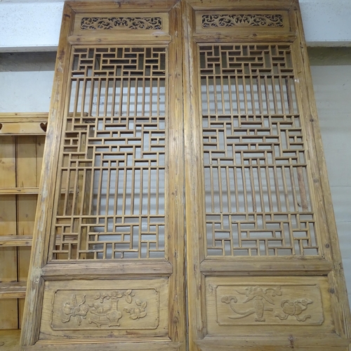 2131 - A pair of oriental doors / panels with applied carved and pierced decoration. Each 69x290cm.