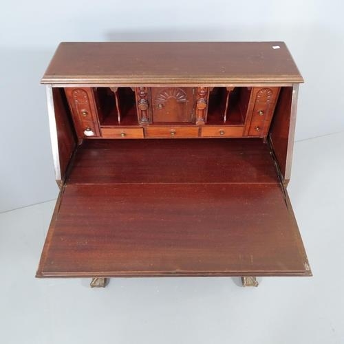 2162 - A reproduction mahogany serpentine front bureau, the fall front revealing a fitted interior with fou... 