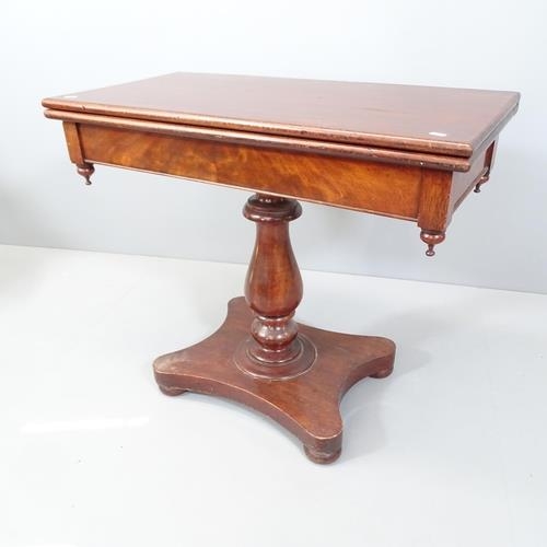 2175 - A 19th century mahogany fold-over tea table, raised on turned central column with platform base. Int... 