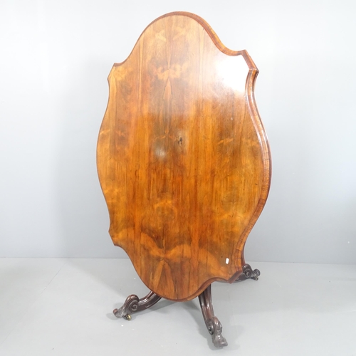 2178 - A 19th century rosewood tilt top Loo table, raised on a turned centre column and sabre leg base. 148... 