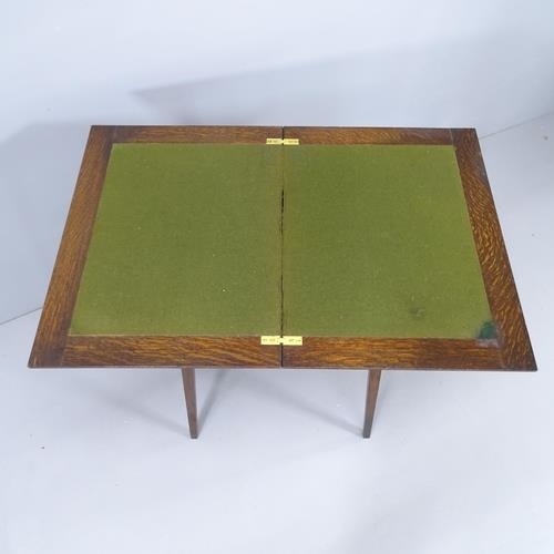 2184 - An early 20th century oak fold-over card table. 51x74x38cm.