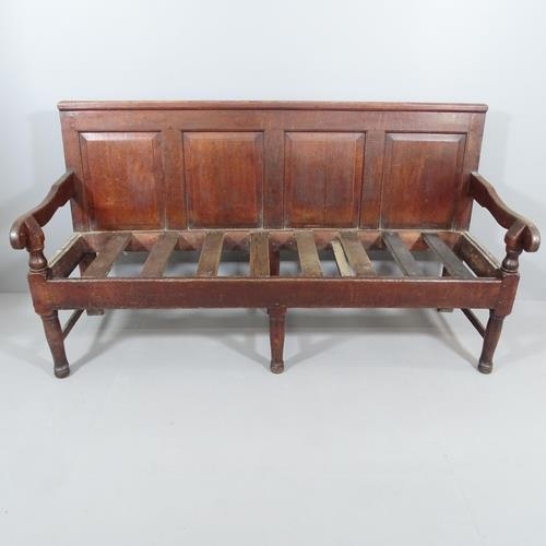 2201 - An 18th Century panelled oak settle, with upholstered cushion over slatted seat. 183x101x69cm.