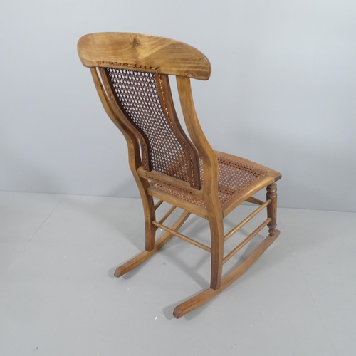 2213 - An elm and oak cane back rocking chair