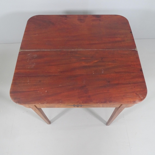 2226 - A regency mahogany fold over tea table, raised on ebony banded tapered legs. 91x74x44cm, opening to ... 