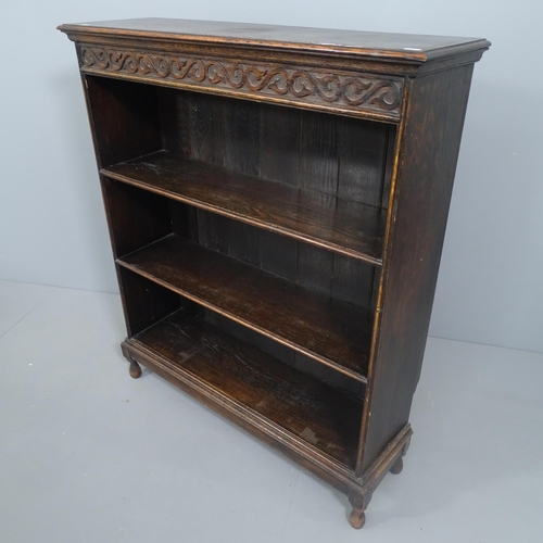 2238 - A 1920's oak open bookcase, carved freeze and two shelves. 92x108x28cm