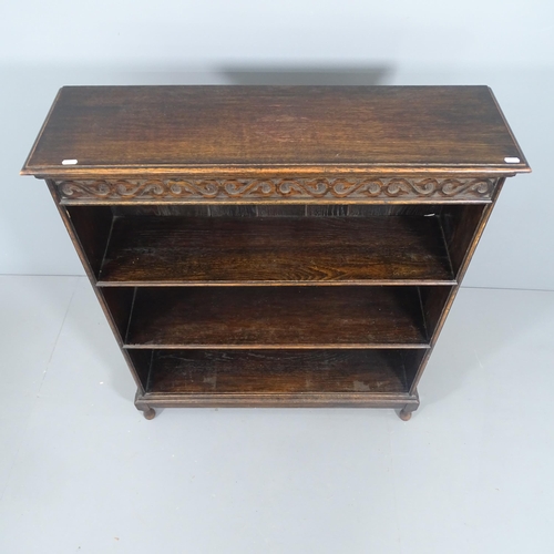 2238 - A 1920's oak open bookcase, carved freeze and two shelves. 92x108x28cm