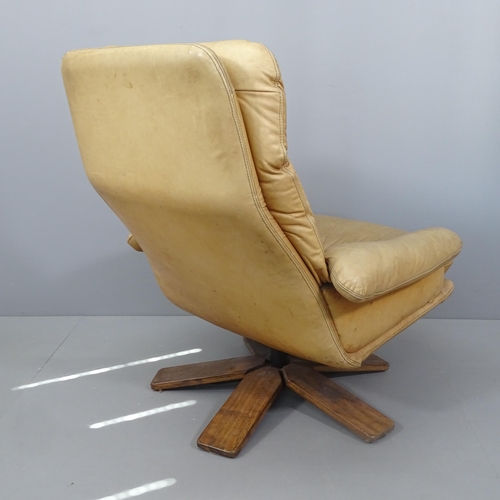 2012 - A mid-century Danish design teak and leather upholstered swivel lounge chair.