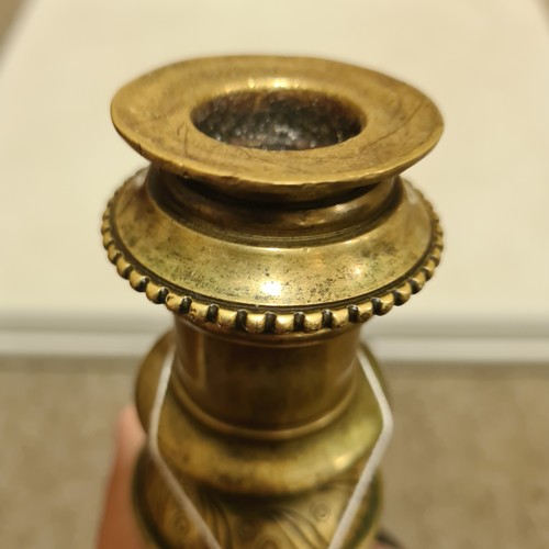 136 - A 19th century brass candle stand on brass lion paw feet, height 32cm