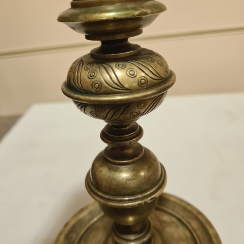 136 - A 19th century brass candle stand on brass lion paw feet, height 32cm