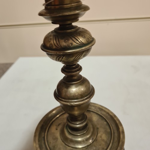 136 - A 19th century brass candle stand on brass lion paw feet, height 32cm