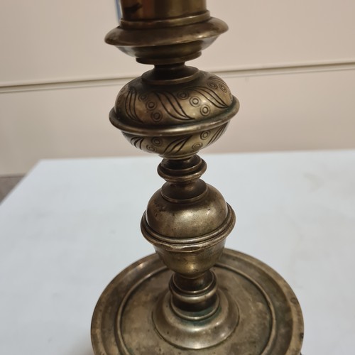 136 - A 19th century brass candle stand on brass lion paw feet, height 32cm