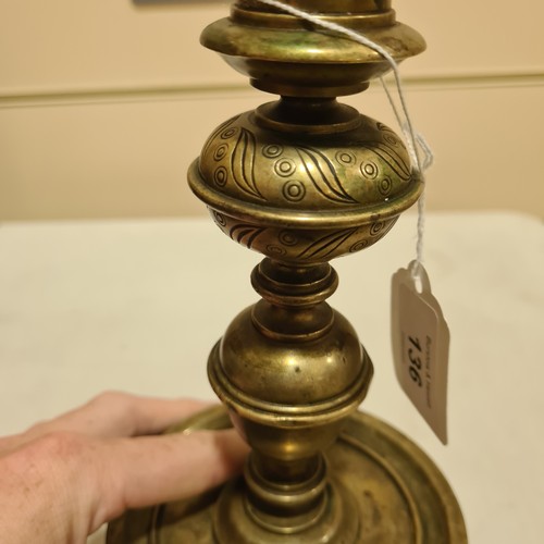 136 - A 19th century brass candle stand on brass lion paw feet, height 32cm