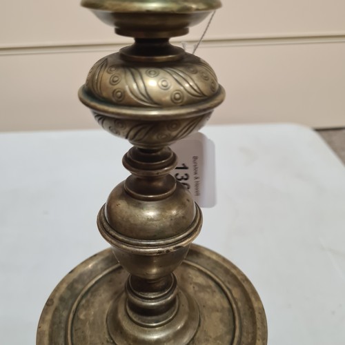 136 - A 19th century brass candle stand on brass lion paw feet, height 32cm