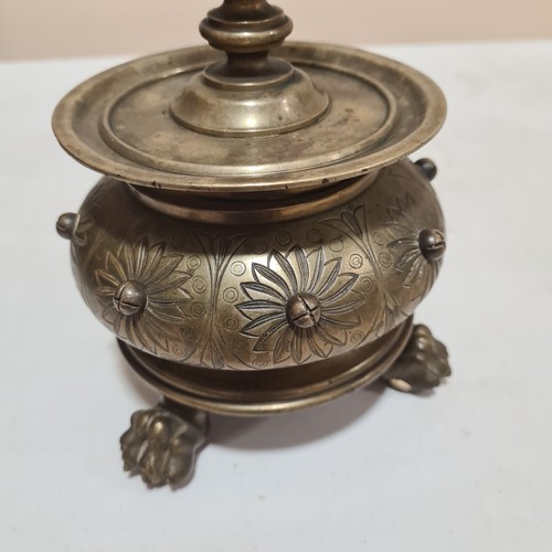 136 - A 19th century brass candle stand on brass lion paw feet, height 32cm