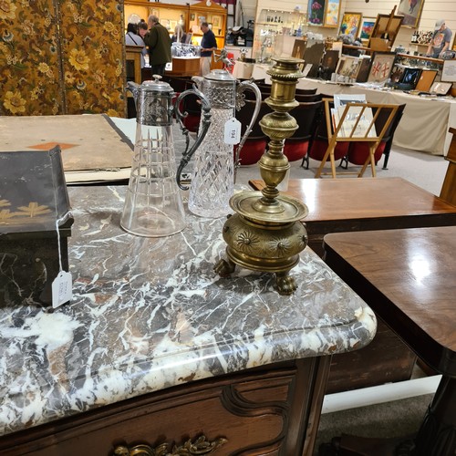 136 - A 19th century brass candle stand on brass lion paw feet, height 32cm