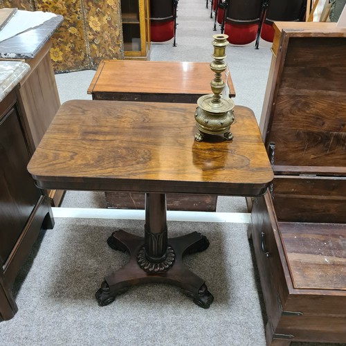 136 - A 19th century brass candle stand on brass lion paw feet, height 32cm