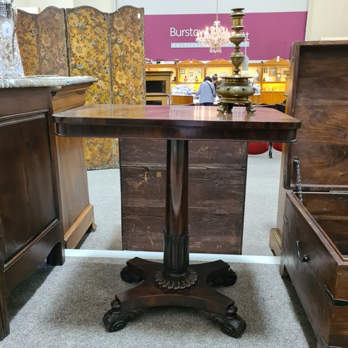 136 - A 19th century brass candle stand on brass lion paw feet, height 32cm