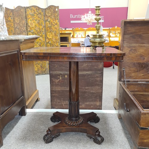 136 - A 19th century brass candle stand on brass lion paw feet, height 32cm