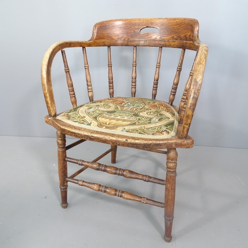 2250 - An antique oak captain's chair with floral upholstered seat.