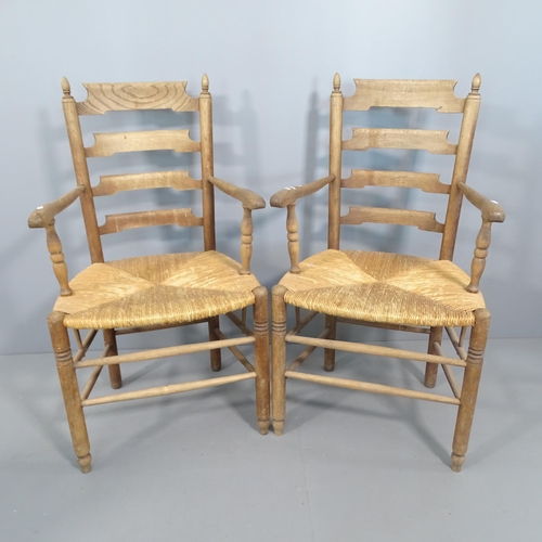 2251 - A pair of French oak ladder back armchairs with rush seats.