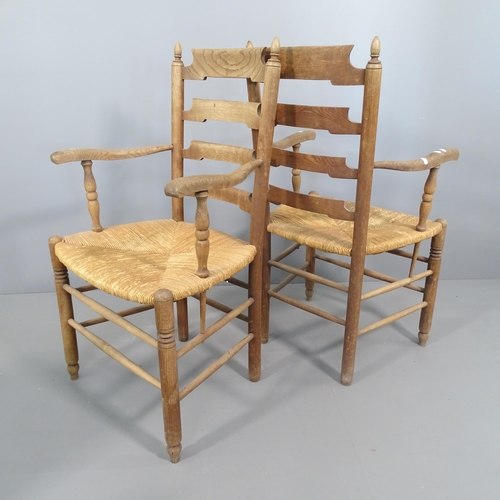 2251 - A pair of French oak ladder back armchairs with rush seats.