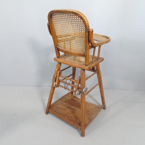 2252 - An antique metamorphic child's high chair with cane seat. 48x92x55cm.