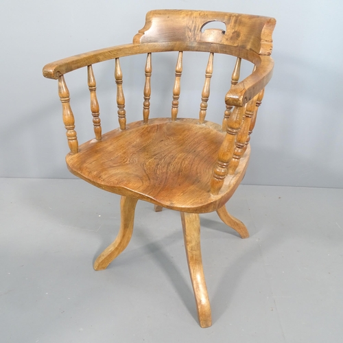 2257 - An antique elm seated captain's chair.