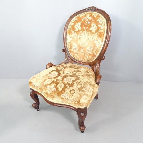 2261 - A Victorian walnut and upholstered spoon back nursing chair.