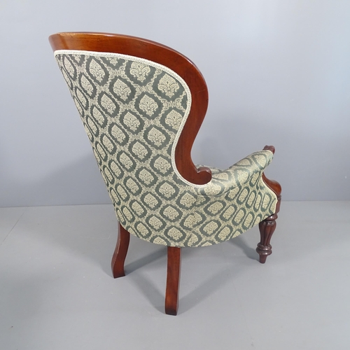 2269 - A Victorian style mahogany and upholstered spoon back armchair.