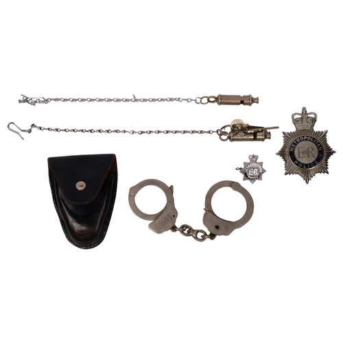 288 - A group of Police items, to include 2 Metropolitan Police whistles, a badge, and a pair of leather-c... 