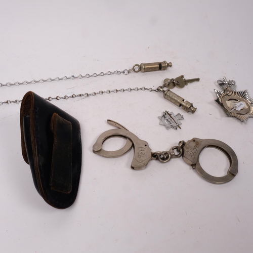 288 - A group of Police items, to include 2 Metropolitan Police whistles, a badge, and a pair of leather-c... 