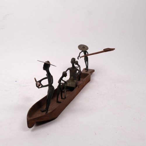 298 - A group of Nigerian bronze fisherman figures and boat, L43cm