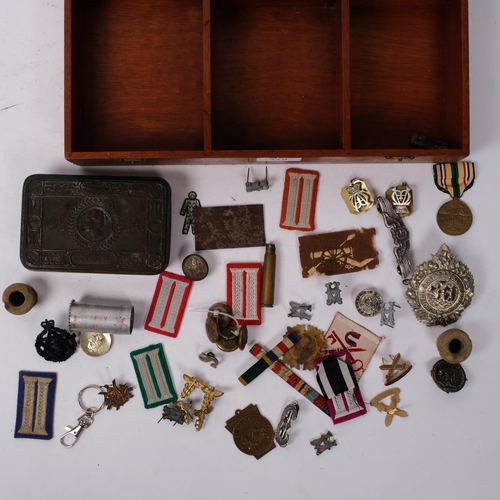 318 - A First World War Period Queen Mary 1914 Christmas tin, various cap and other badges including the A... 