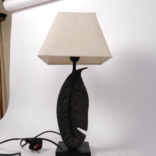 366 - A contemporary cast-metal table lamp in the form of a feather, with LED bulb, and shade, overall hei... 