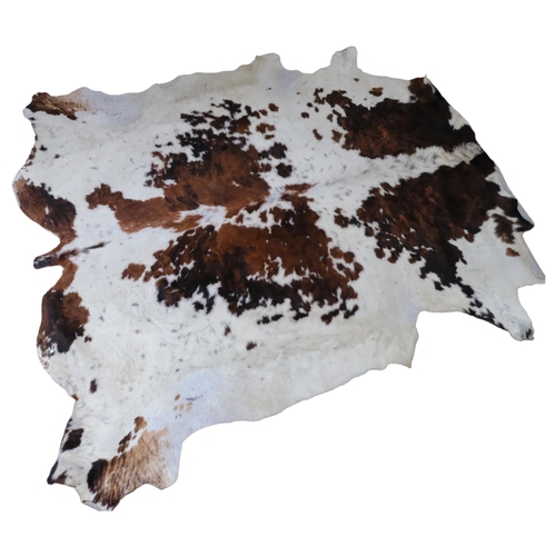 382 - A large cowhide, W230cm x 220cm approx