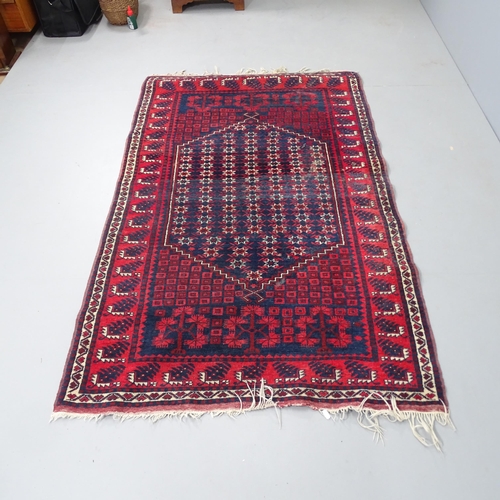 2330 - A red-ground Afghan rug. 183x115cm